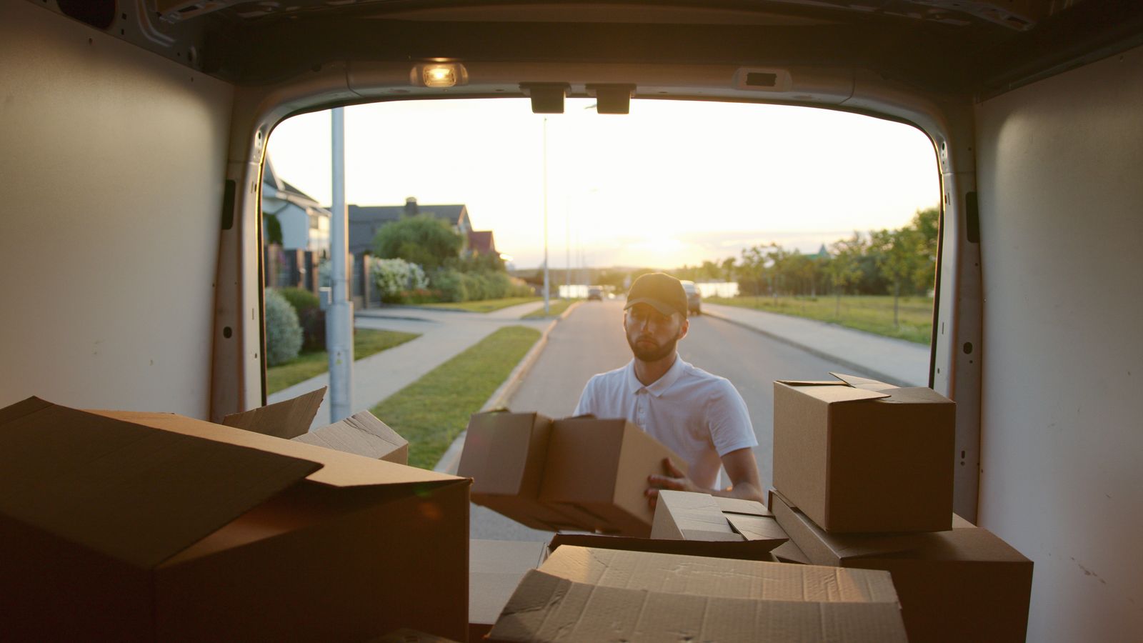 Boxes being loaded into a van on a residential street
