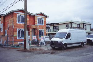 White van parked at the kerb directly outside a house on moving day